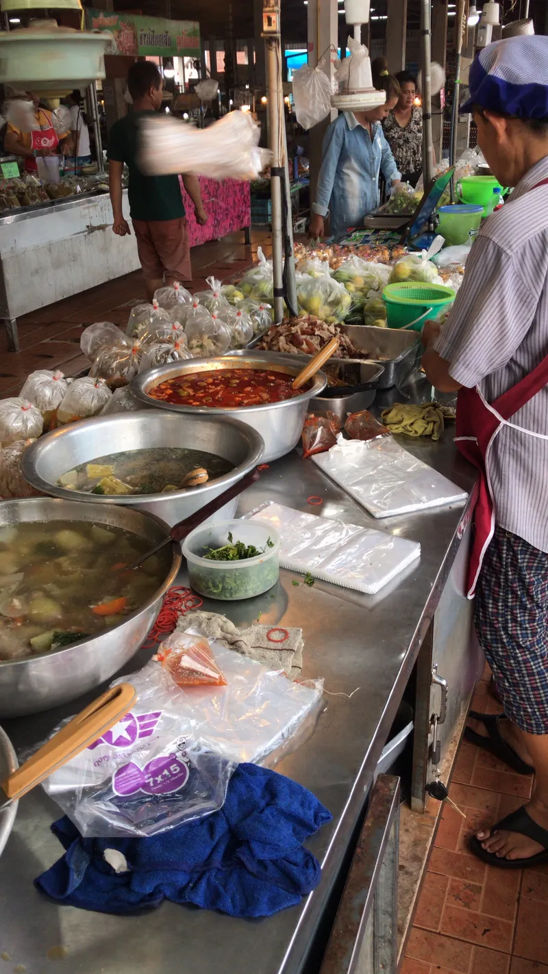 Pots of curry and broth at the market stall